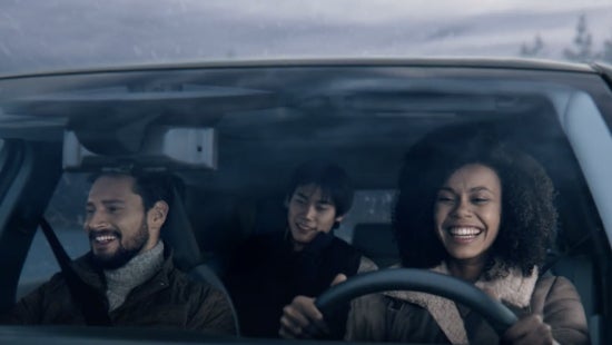 Three passengers riding in a vehicle and smiling | Dave Syverson Nissan in Albert Lea MN